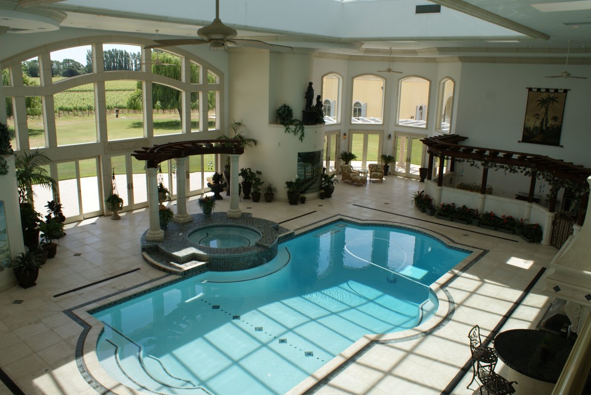 and-the-home-has-an-indoor-pool-the-room-has-four-skylights-with-34-foot-windows-looking-out-to-the-lawn