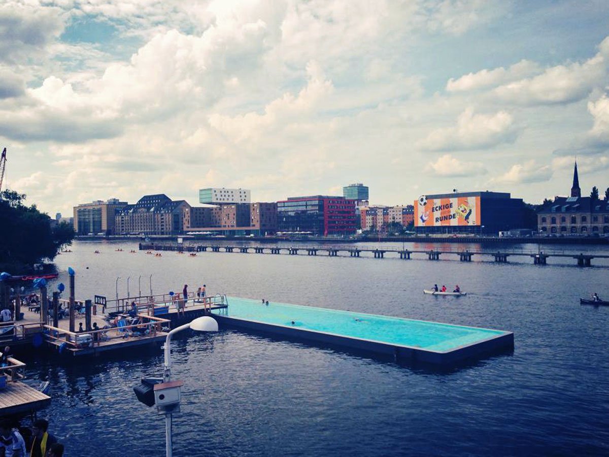 berlins-arena-badeschiff-pool-floats-inside-of-the-river-spree-where-visitors-can-swim-in-clean-water-and-enjoy-views-of-the-surrounding-city-food-drinks-music-and-lounge-chairs-are-also-available-from-open-to-close