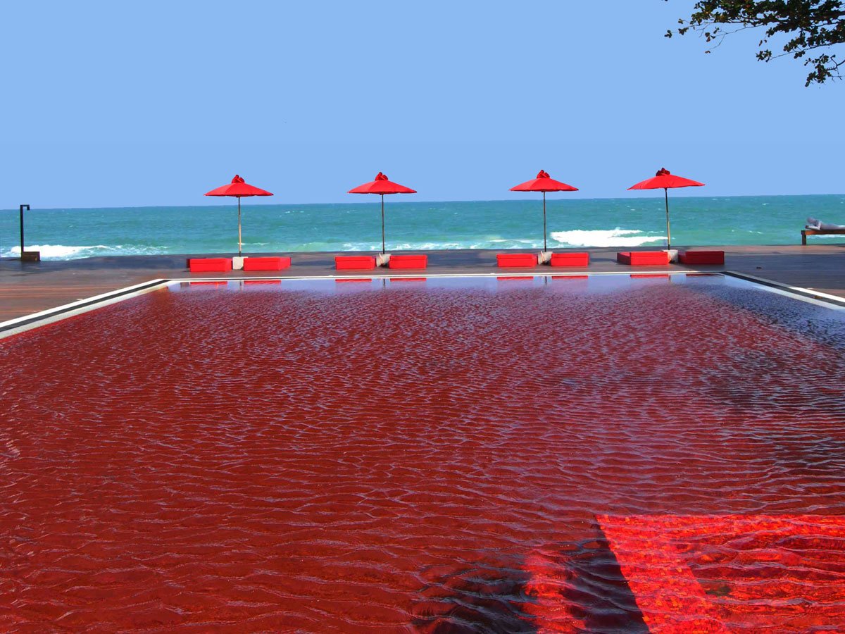 the-library-in-thailand-has-a-pool-boasting-a-unique-look-with-blood-red-tiles-creating-a-cool-effect-that-nicely-contrasts-the-beach