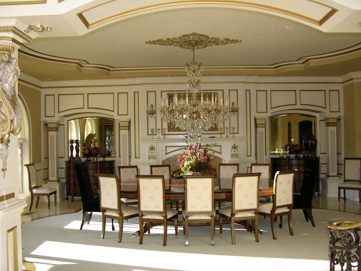 while-the-12-person-formal-dining-room-has-gold-trimmed-walls-and-a-swarovski-crystal-chandelier